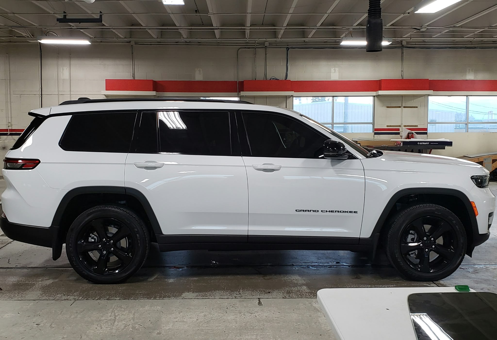 White SUV inside the Tint X installation shop